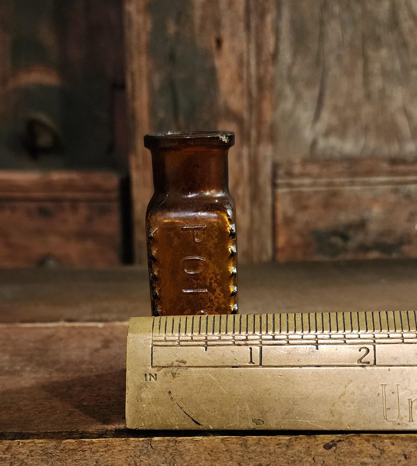 Antique Embossed Amber Poison Bottle