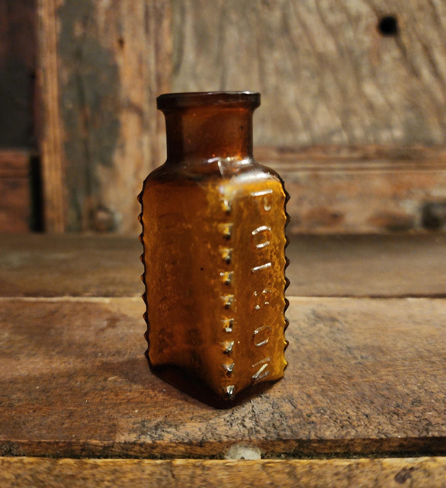 Antique Embossed Amber Poison Bottle